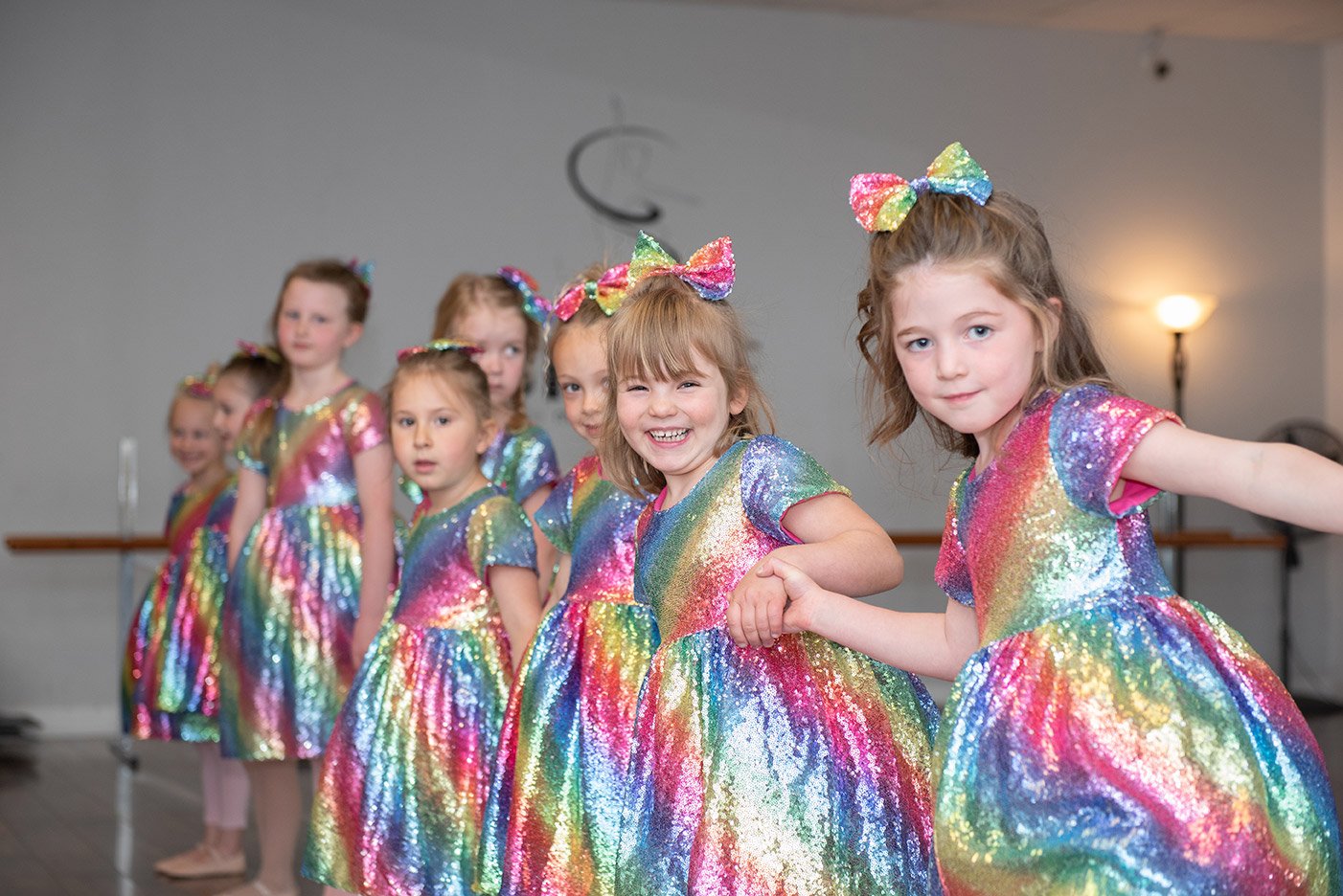 Young dancers from Mrs. Marcelle's School of Dance in rainbow sequin costumes.